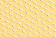 White Capsules on Yellow Background