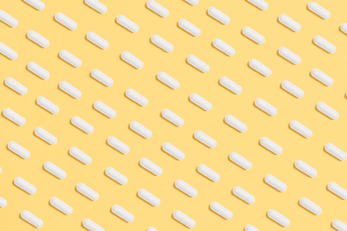 White Capsules on Yellow Background