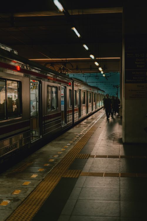 Free Capturing the solitude of a Jakarta train platform at night, with moody lighting enhancing the scene. Stock Photo