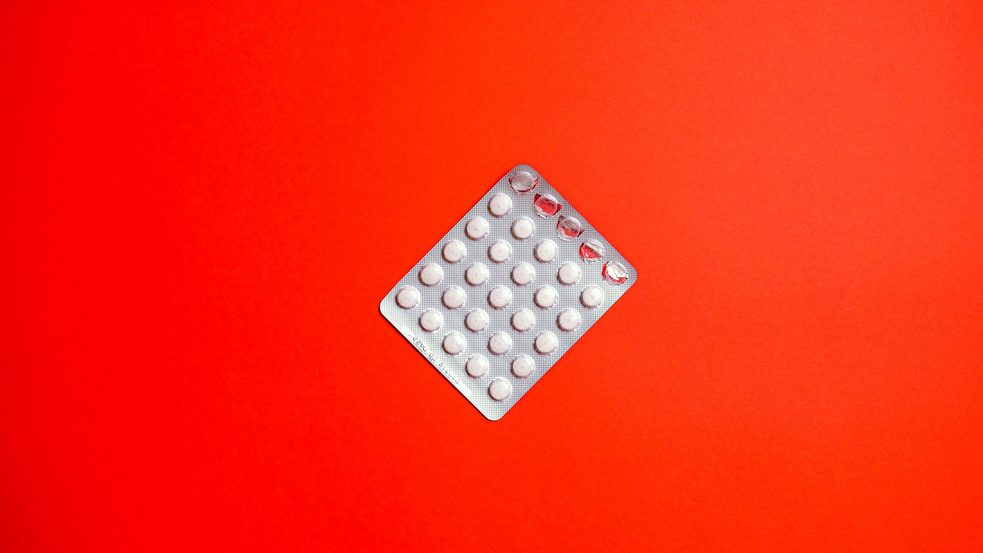 Modafinil and Birth Control Interaction: What You Need to Know Close-up of a blister pack of pills against a solid red background symbolizing healthcare and medication — modafinil and birth control interaction