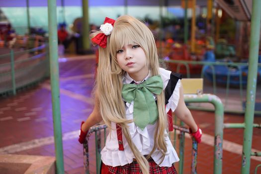 Vibrant cosplay portrait taken in an amusement park in Surabaya, Indonesia, capturing colorful character costume.