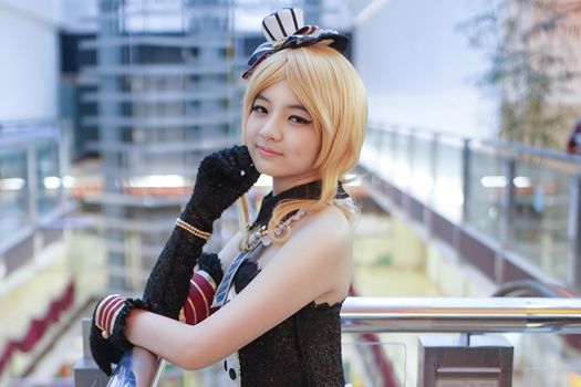 Cosplay enthusiast dressed in elaborate costume posing inside Surabaya mall.