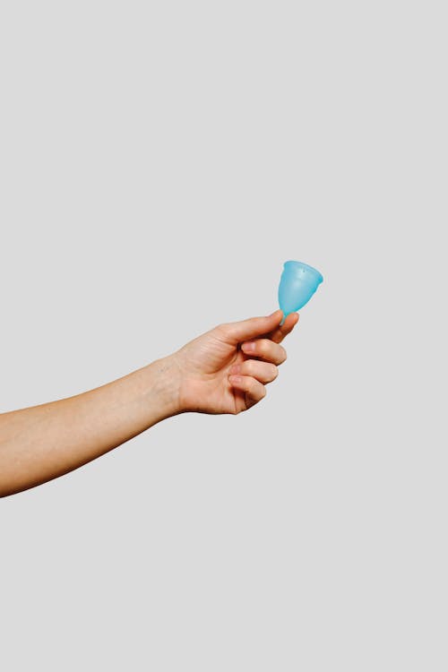 Person Holding Blue Menstrual Cup