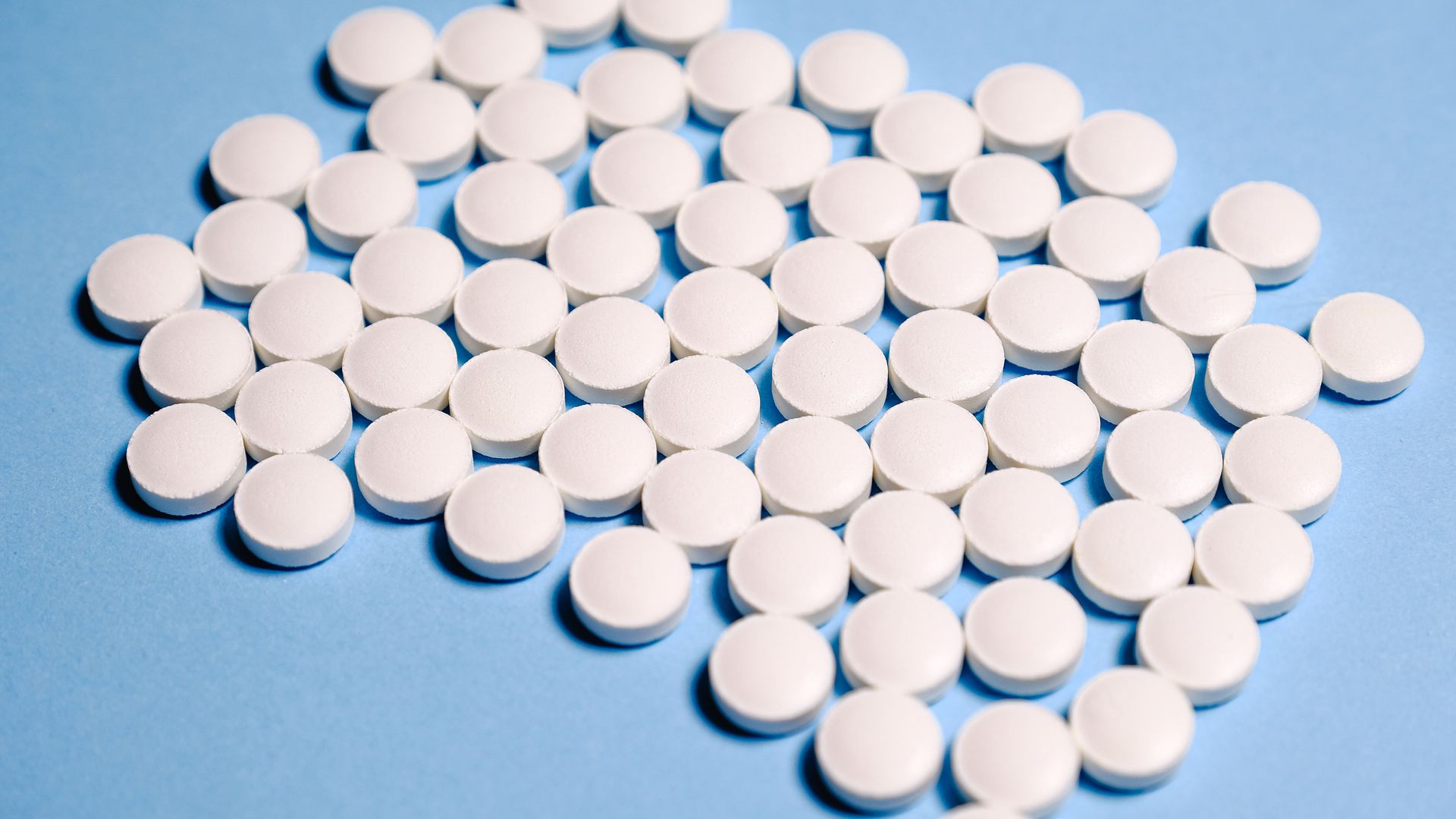 Modafinil FDA Approved Uses: Unlocking the Mystery Close-up of white pills on a blue surface representing healthcare and medication.