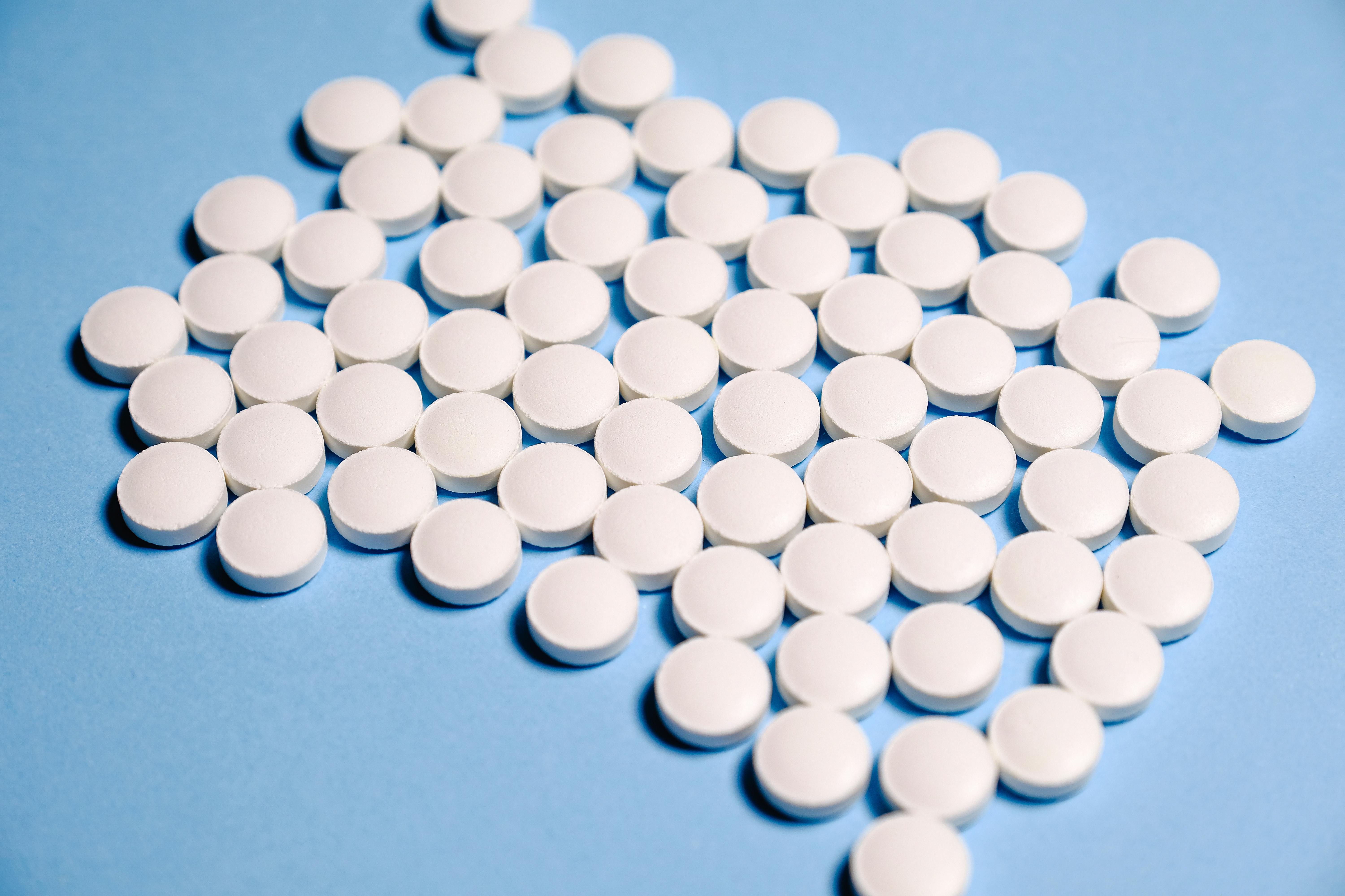 White Medication Pill on Blue Textile \u00b7 Free Stock Photo