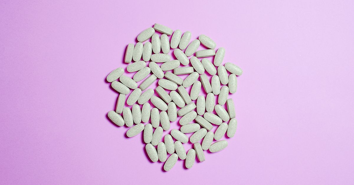 Supplement capsules and a glass of water