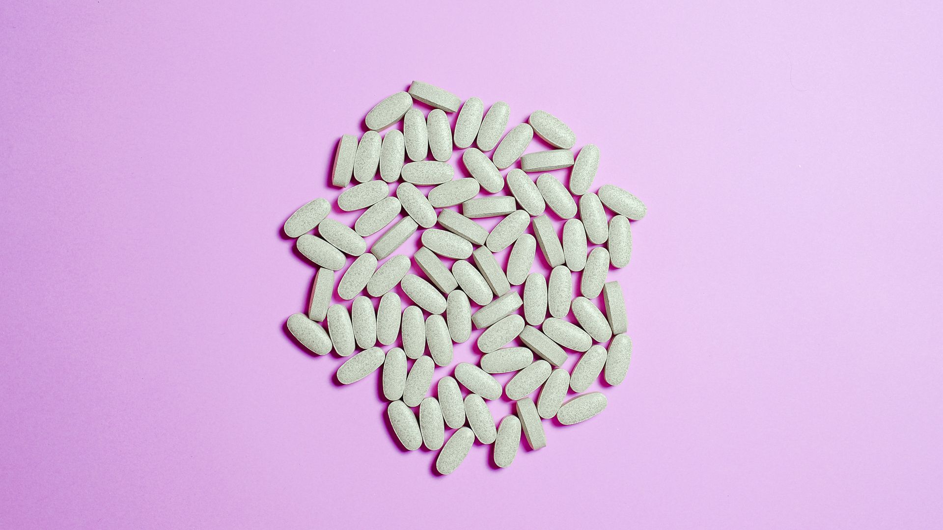 What Are Nootropics? Unlocking the World of Smart Drugs A cluster of white pills on a purple surface, highlighting pharmaceutical themes — what are nootropics