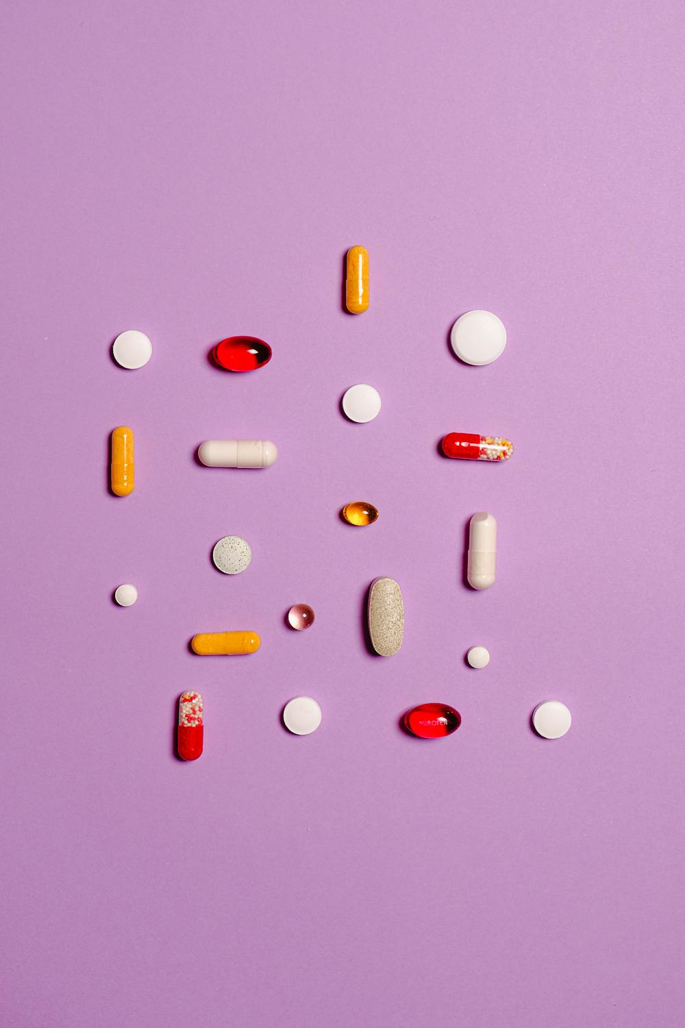vitamins and minerals on pink background