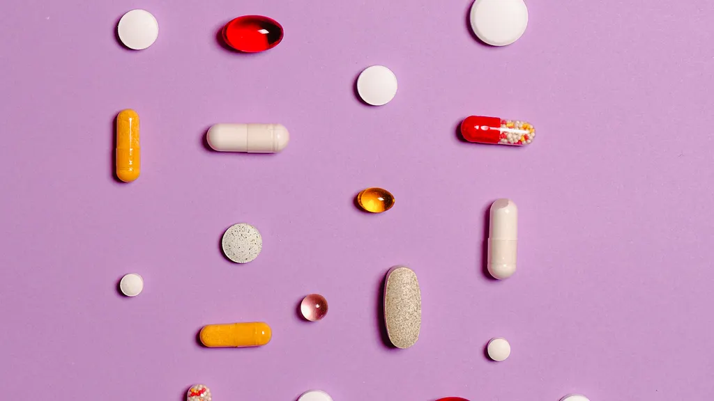 Assorted medication pills on a purple background