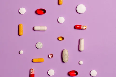 Assorted medication pills on a purple background