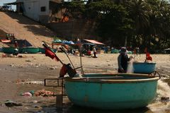 Traditional Vietnamese basket boats on a lively beach reflecting local fishing culture in Vietnam.