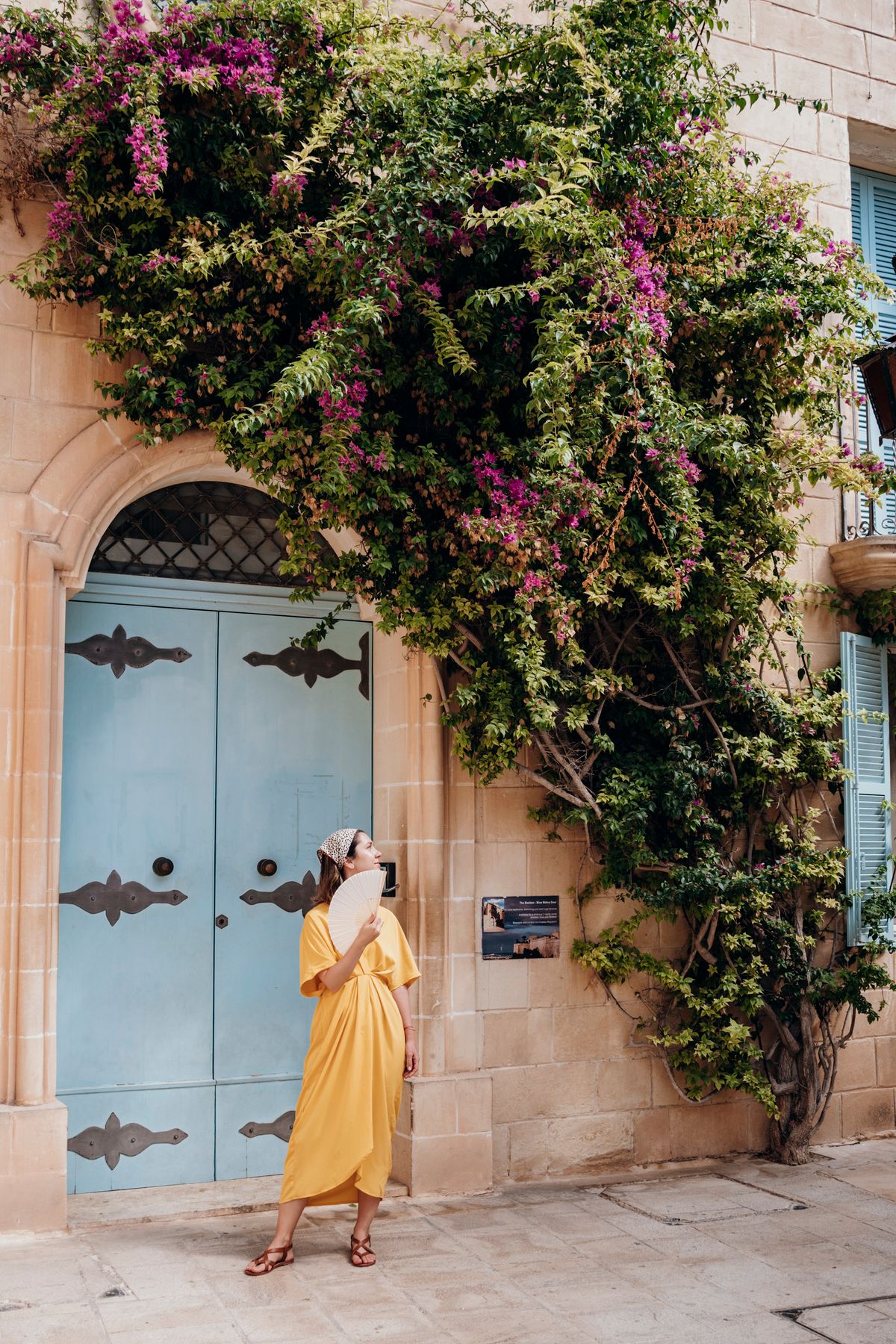 A charming Mediterranean street with bougainvillea — the setting for a European summer wardrobe