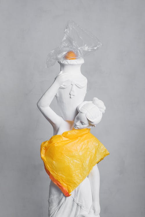 女人白色雕塑和橙色塑料