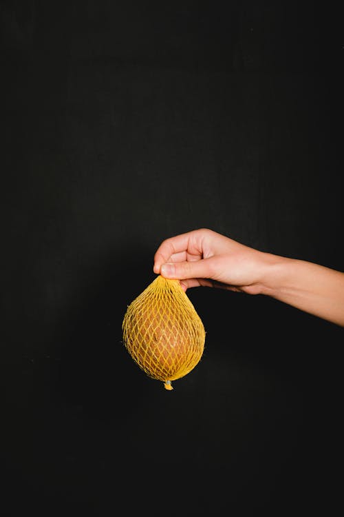 Person Holding a Fresh Fruit 