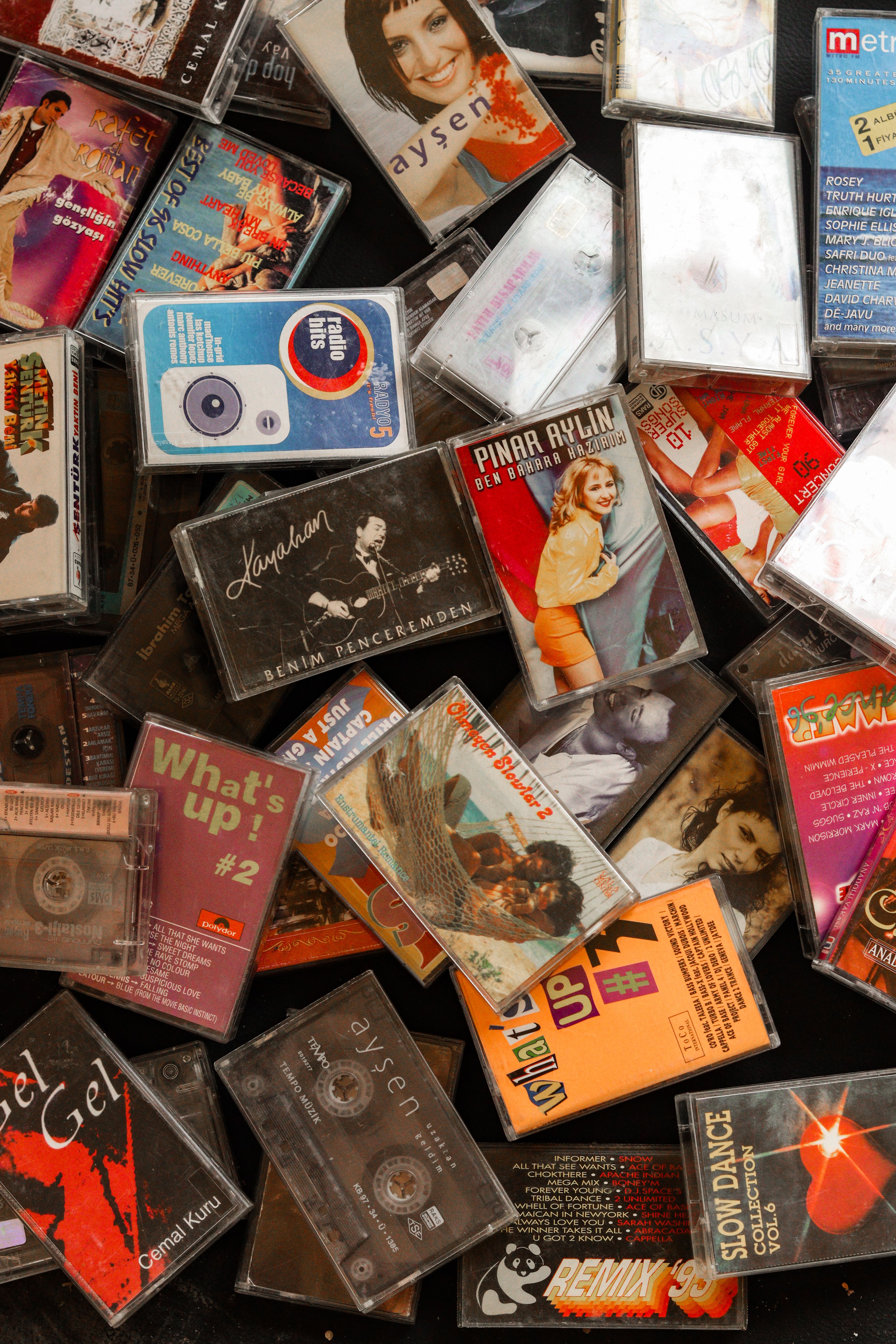 A nostalgic flat lay of diverse vintage cassette tapes showcasing 90s music culture.