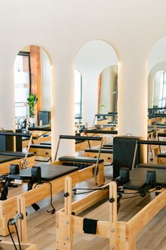 Bright and spacious Pilates studio featuring modern reformer equipment and elegant design.