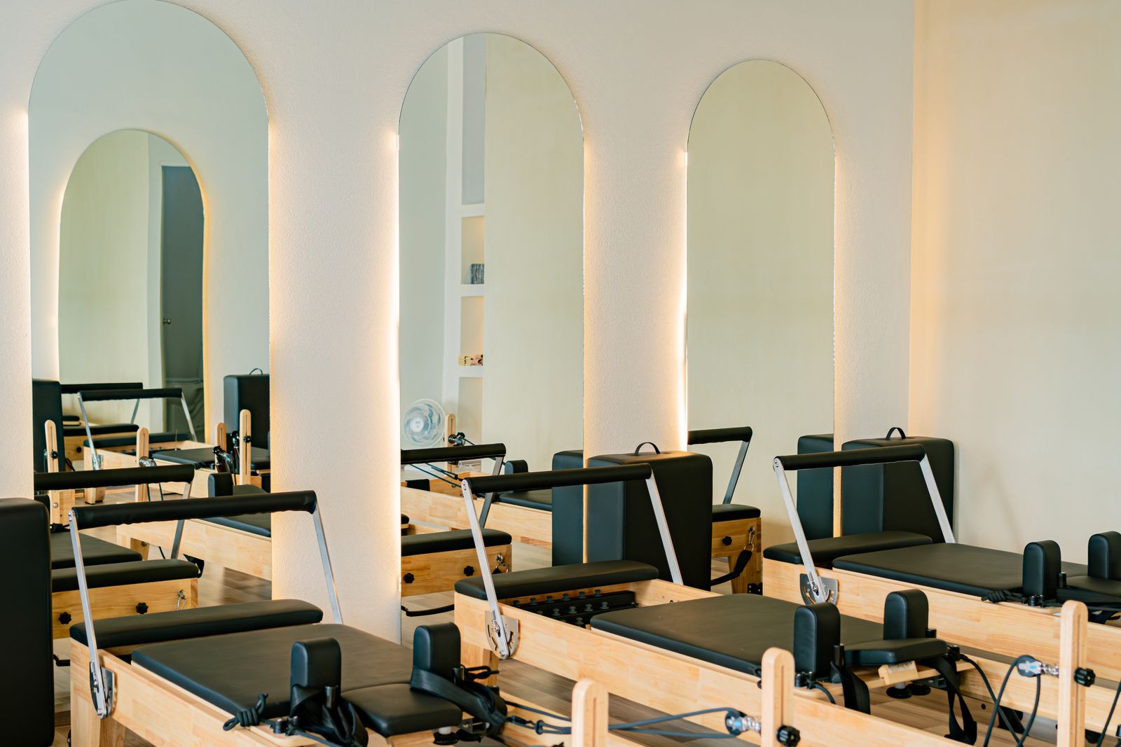 Bright private Pilates studio with reformer equipment and calm finishes