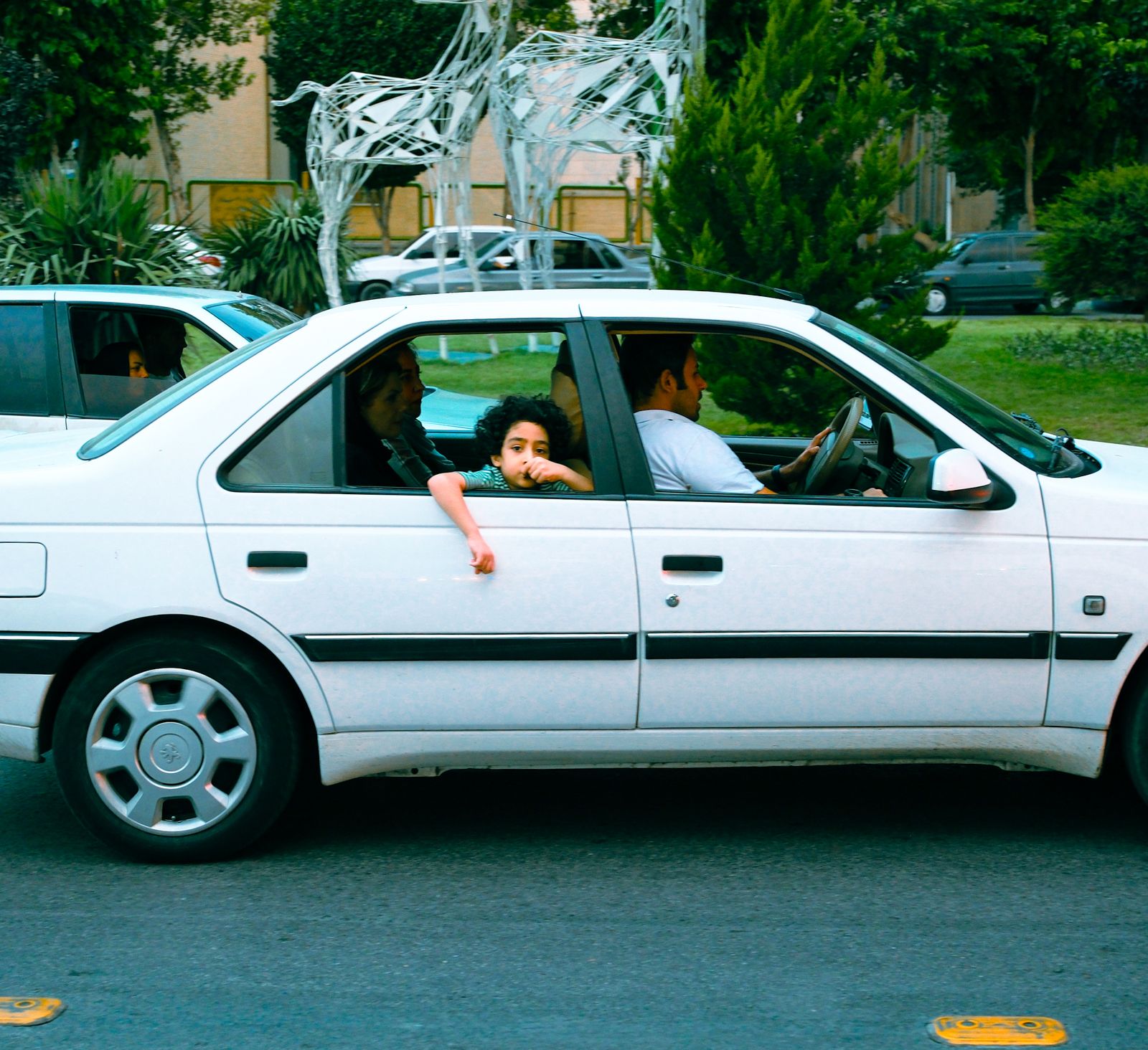 Child looking out car window during a family move