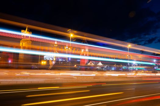 Vivid city night scene featuring light trails and illuminated landmarks.