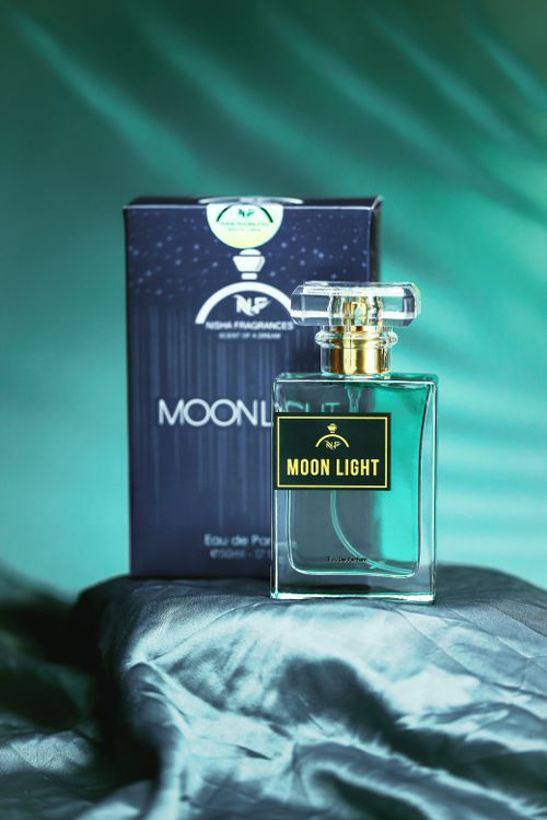 Free A luxurious Moonlight perfume bottle with a cinematic backdrop, embodying elegance and style. Stock Photo