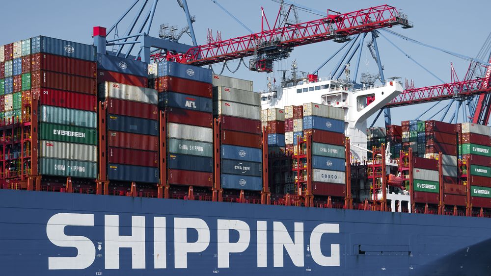 Container ship with cranes at a European port