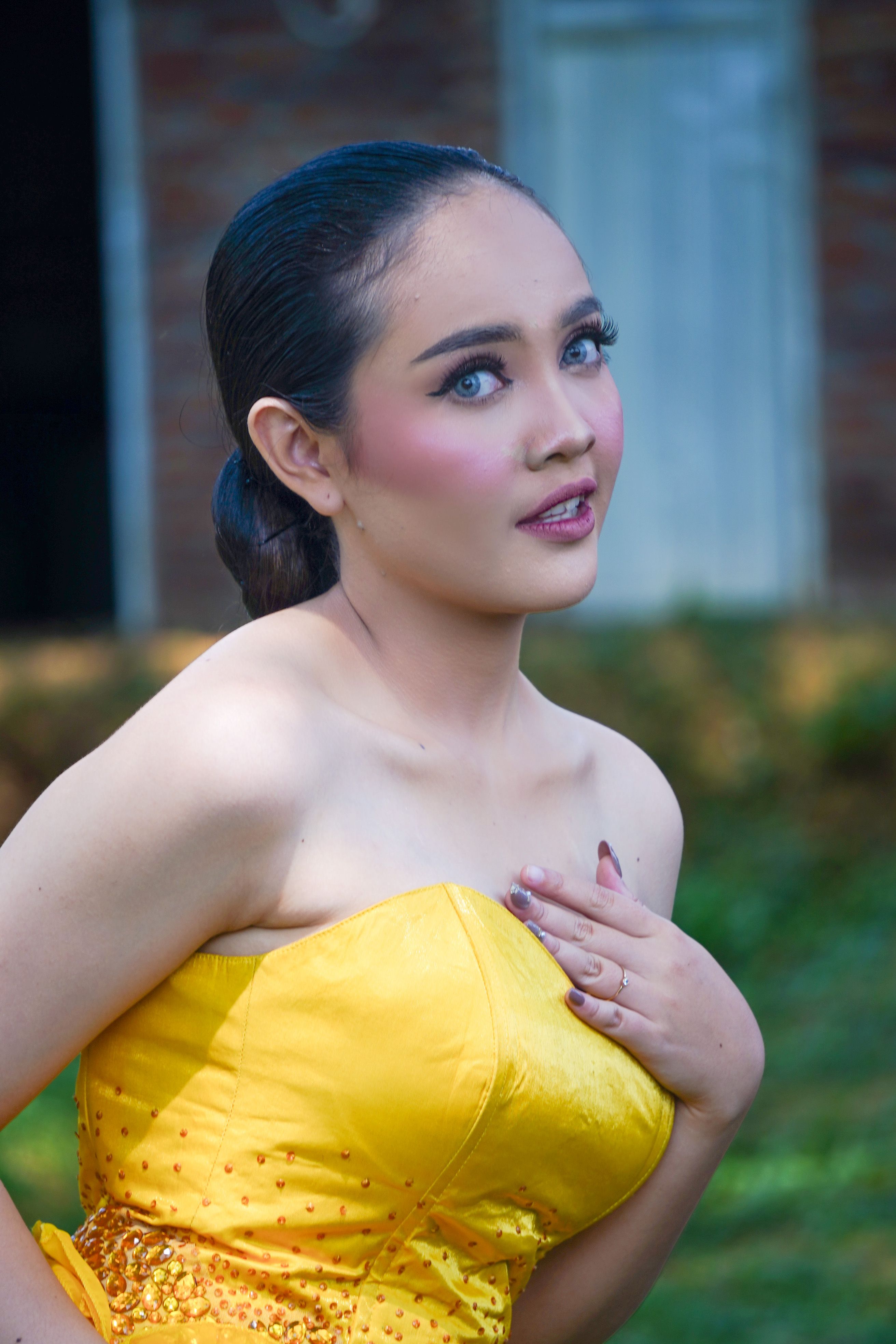 Elegant woman in a bright yellow dress
