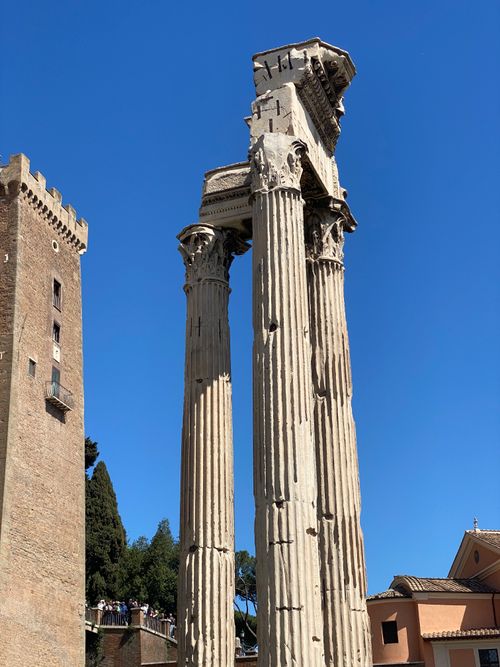 Free Majestic ruins of an ancient Roman temple with clear blue sky background. Stock Photo