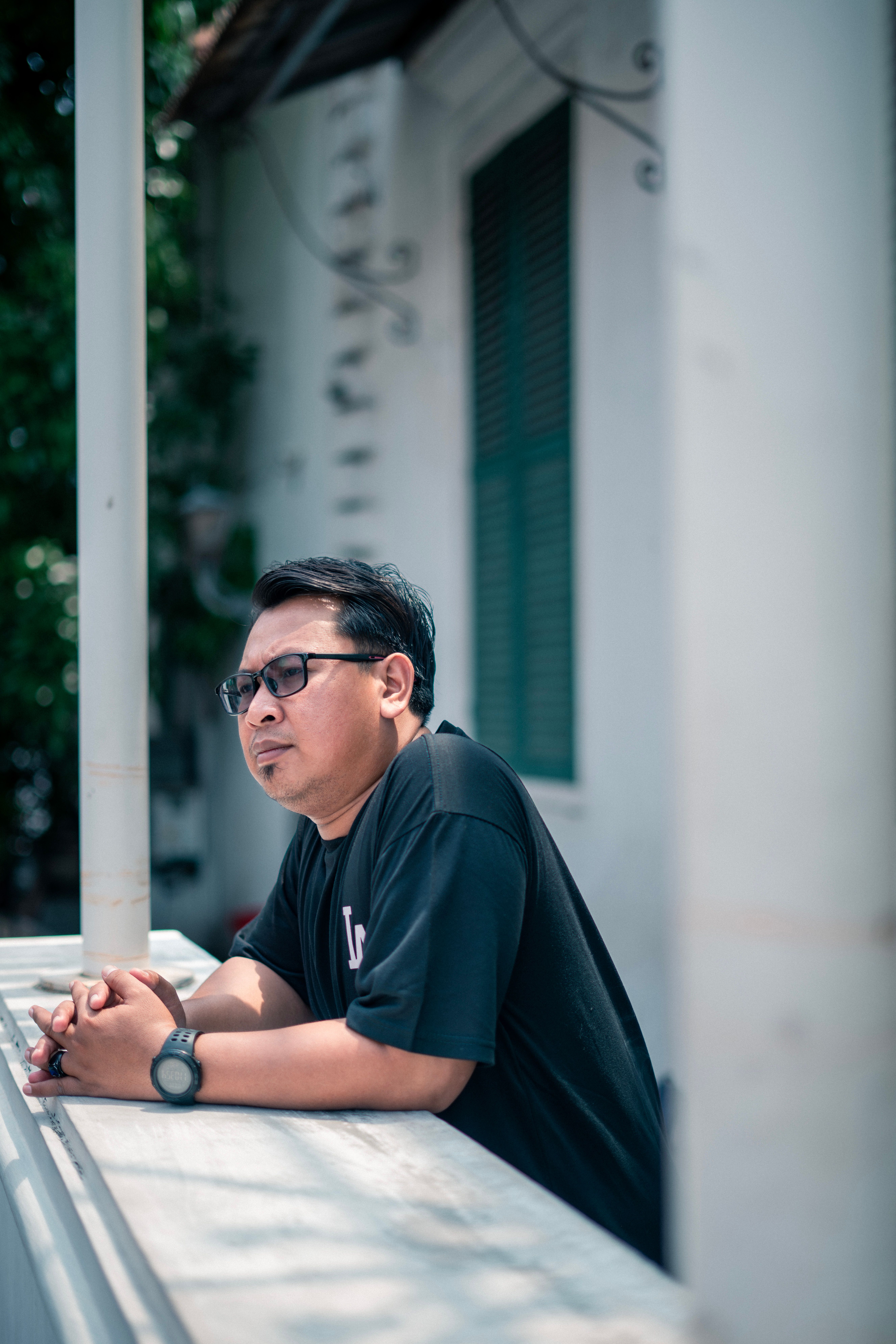Contemplative Man on Balcony in Jakarta