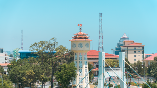 Free Urban cityscape with a distinctive tower and modern bridge in Vietnam under clear sky. Stock Photo