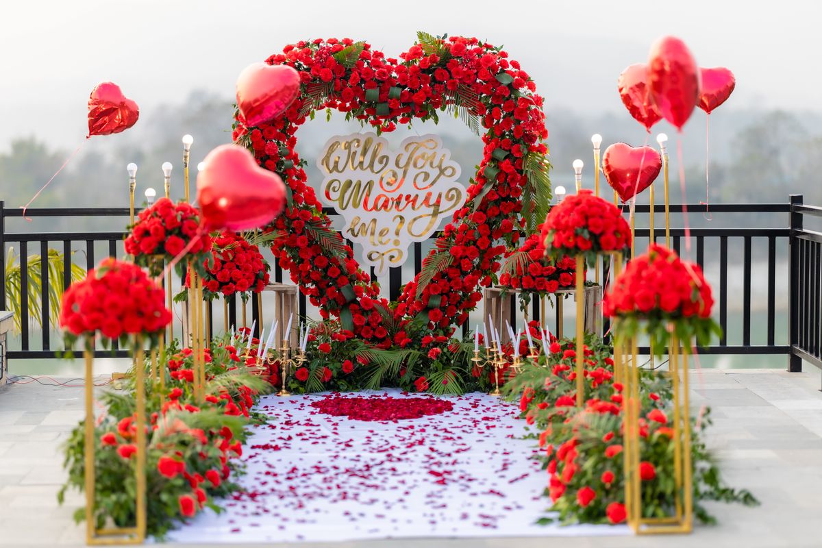 Romantic proposal setup with flowers and lights