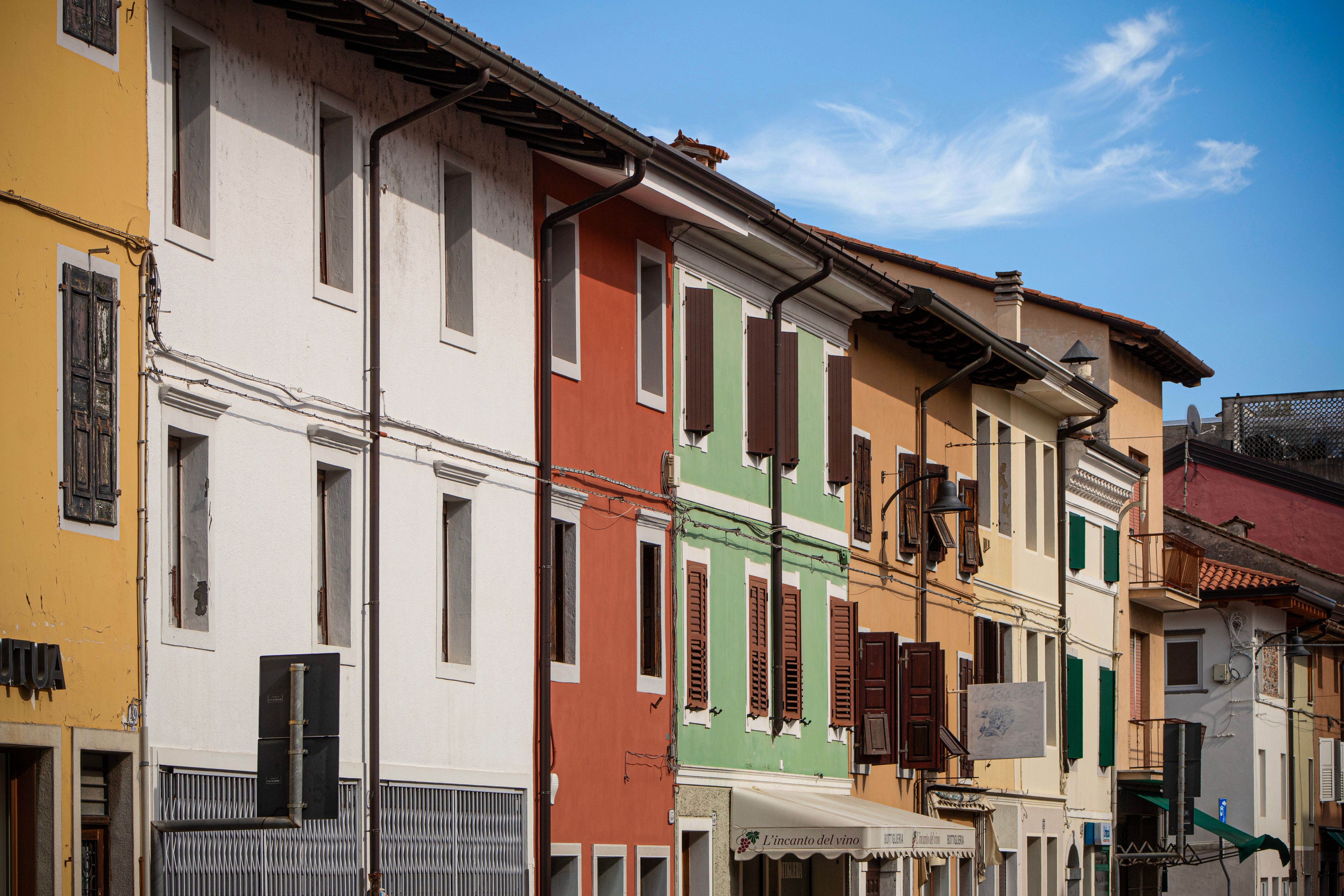 Vibrant facades of traditional Italian buildings in Palmanova, showcasing colorful architecture.