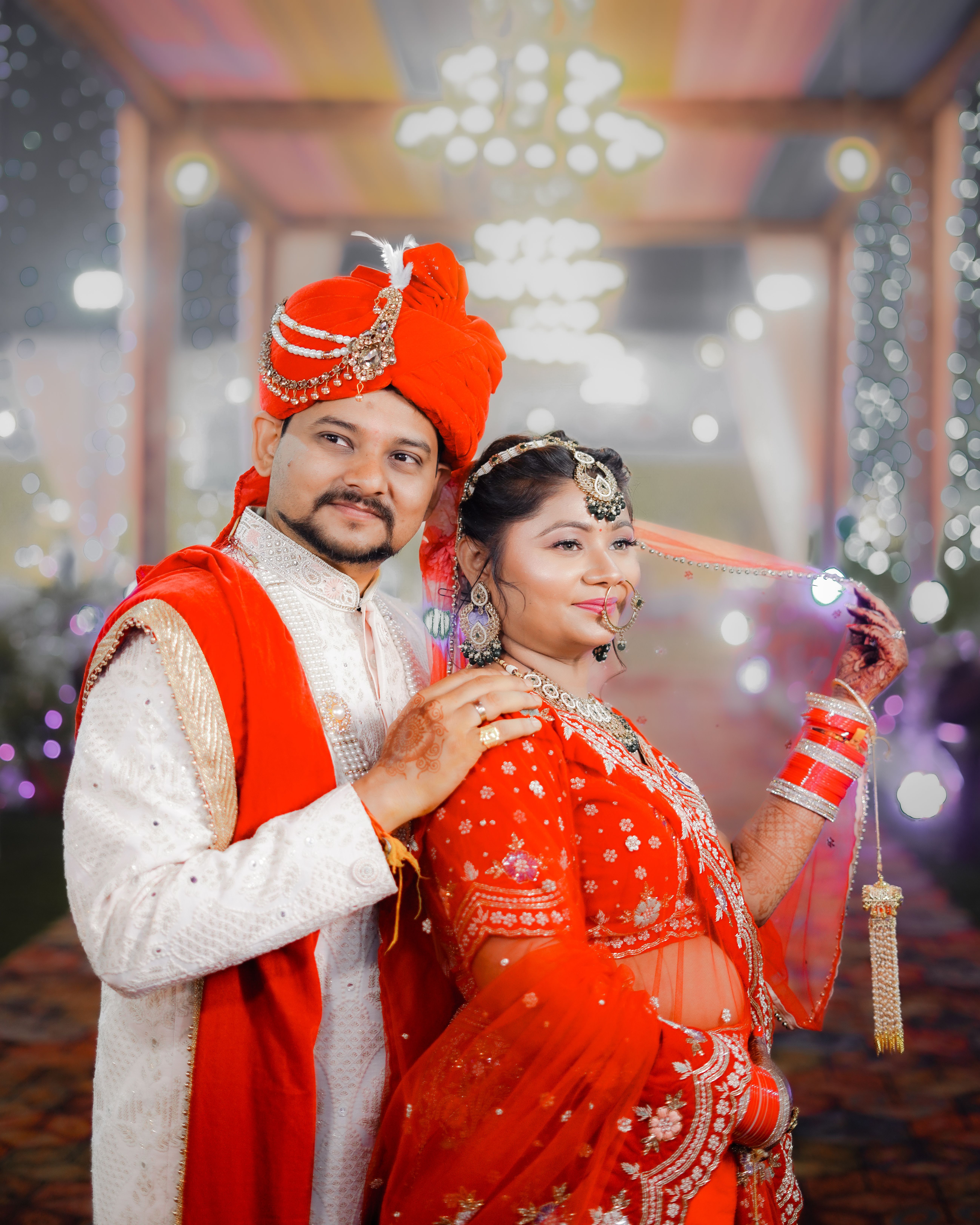 A beautiful Indian couple posing in traditional attire during their wedding ceremony.