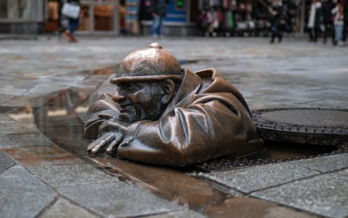 Brown Concrete Statue on Gray Concrete Pavement