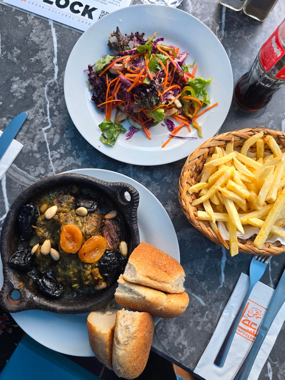 Traditional Moroccan tagine served with salad, bread and sides
