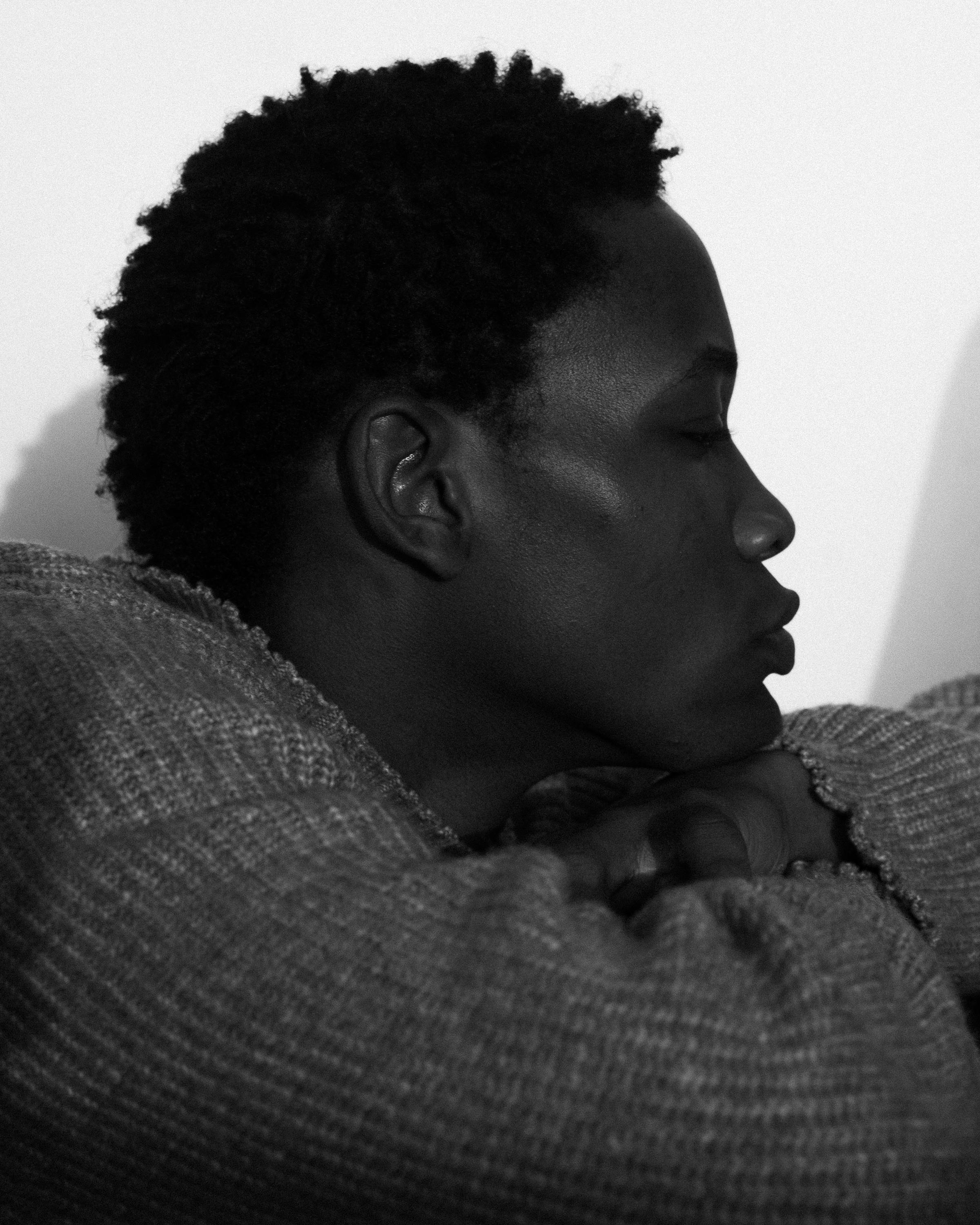 Stylish side profile of a young man in Lagos, captured in black and white, showcasing timeless fashion.