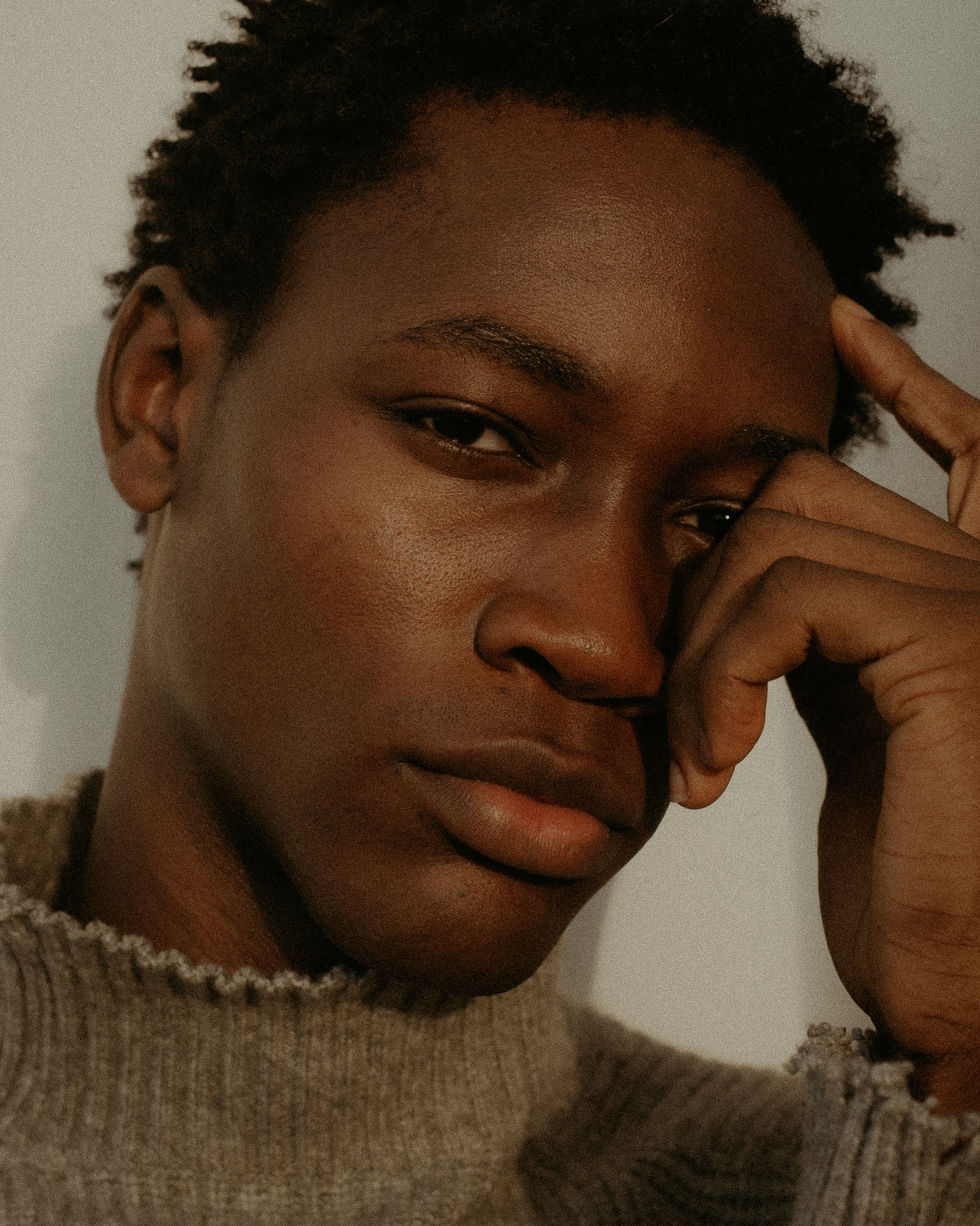 Close-up portrait capturing contemplative expression of a young man in Lagos, Nigeria.