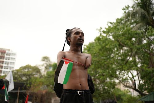 Free A determined activist holds a flag during an outdoor protest in Dhaka, Bangladesh. Stock Photo