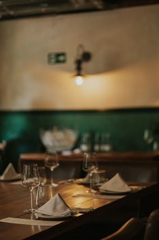 A warm and inviting restaurant interior with elegantly set tables, perfect for fine dining.