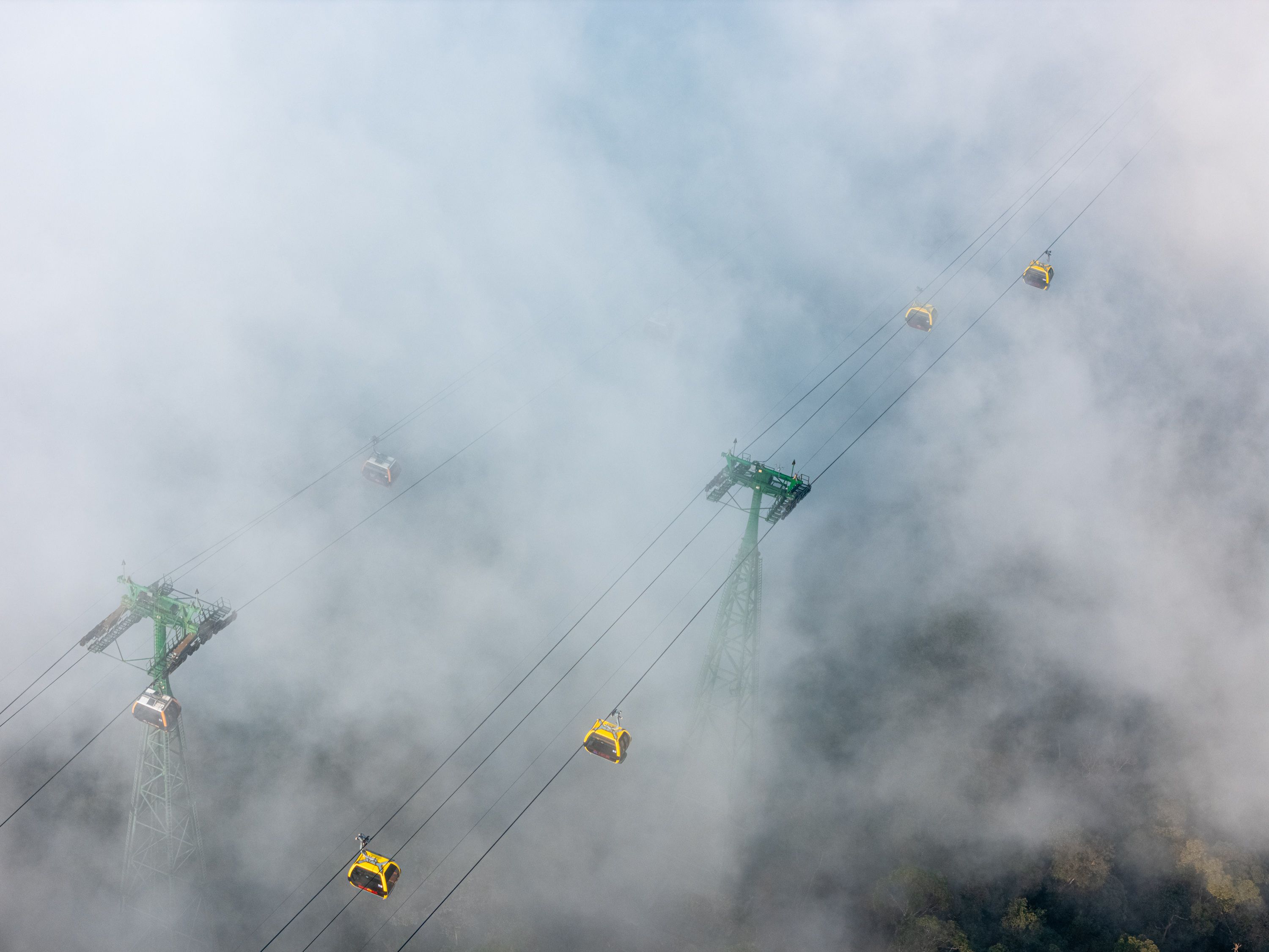 Langkawi SkyCab cable car ascending over lush rainforest in Langkawi, Malaysia