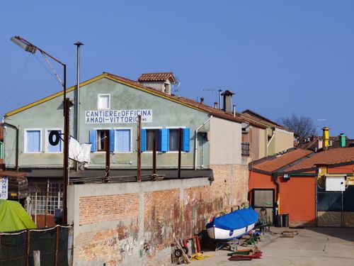 Free Vibrant buildings and boatyard in Burano, Veneto, showcasing Venetian charm. Stock Photo