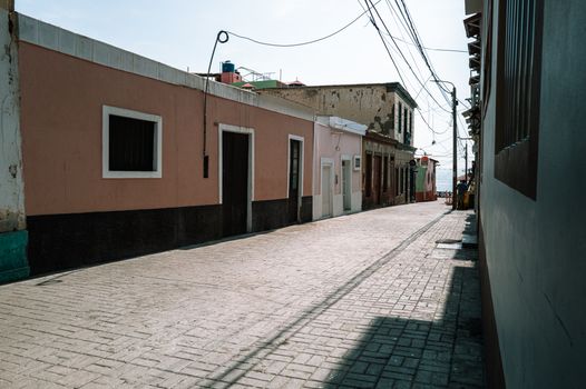 Charming street scene in Pacasmayo, La Libertad, Peru, showcasing traditional architecture.