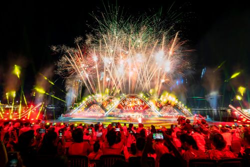 Free Vibrant fireworks display during Vietnam cultural festival at night with large audience captured in dynamic scene. Stock Photo