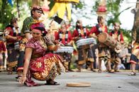 Vibrant Balinese cultural dance featuring musicians in traditional attire performing outdoors.