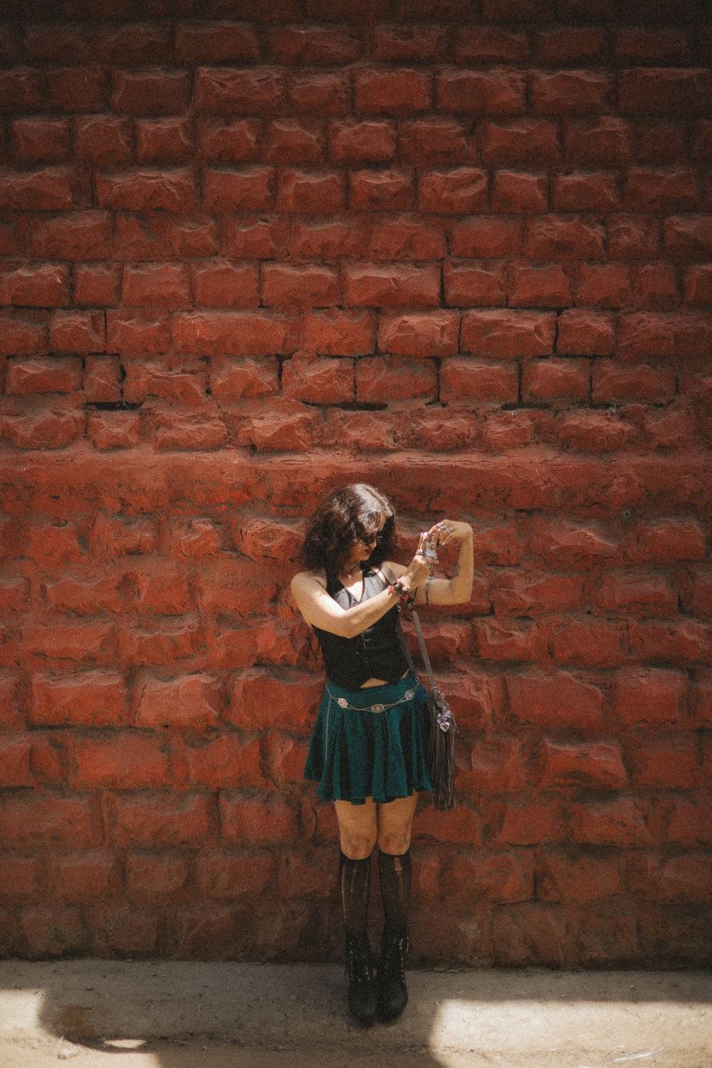 Woman Posing Against Rustic Red Brick Wall · Free Stock Photo