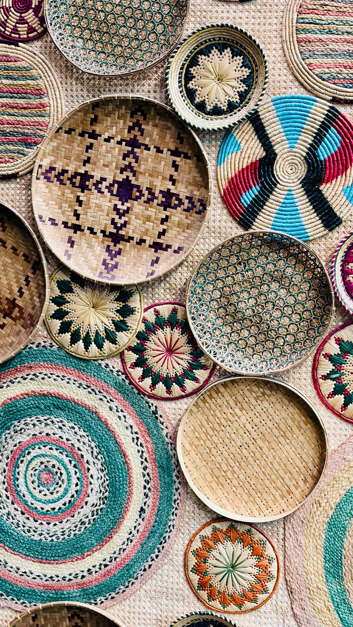 Handwoven seagrass basket used for coffee supply storage on a boho coffee bar shelf