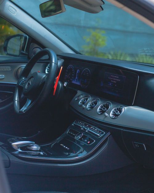 Free Elegant view of a Mercedes-Benz interior showcasing a sleek dashboard, digital display, and premium materials. Stock Photo