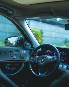 Luxury Mercedes Benz interior showcasing sophisticated dashboard and steering design.