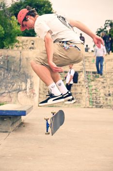 Dynamic shot of a young skater mid-air performing a trick at a bustling urban skate park.. pexels, dynamic, shot