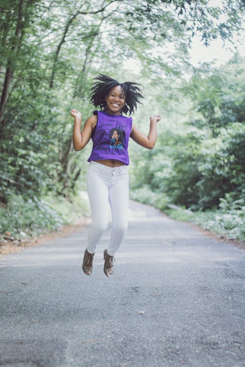 Woman Jumping on Pathway