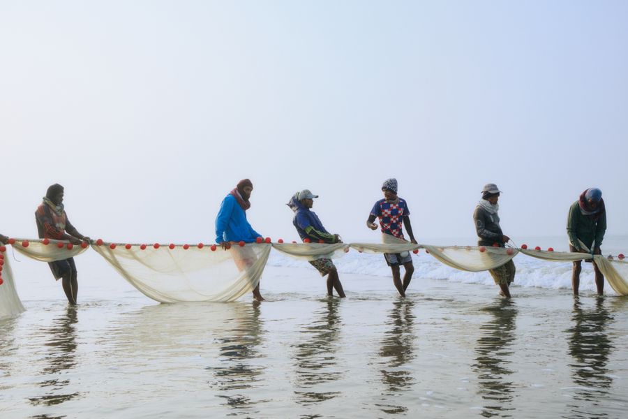 Fishermen pulling nets at Cox’s Bazar beach